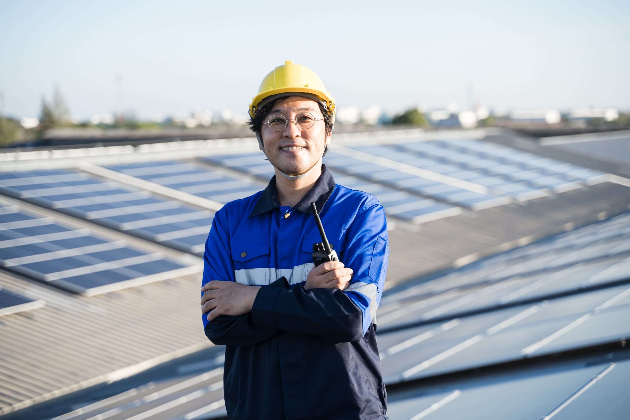 Portrait of Asian engineer in front of solar panels