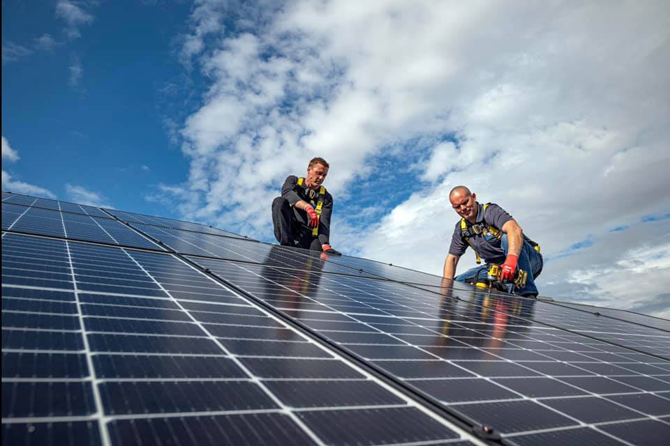 2 technicians installing solar panels
