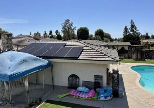 black solar panels on top of house roof in Bakersfield, CA