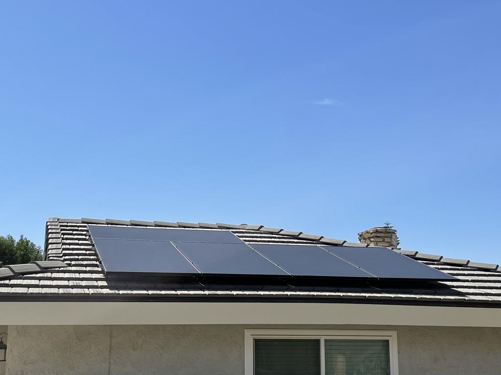 solar panels installed on roof with blue sky background