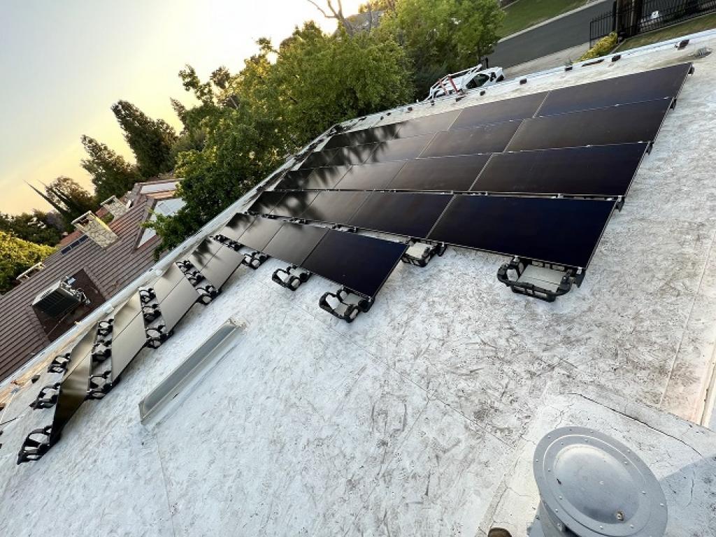 various black solar panels installed on grey roof with tiles in Bakersfield, CA