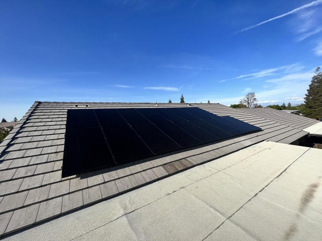 black solar panel installed on tile roof