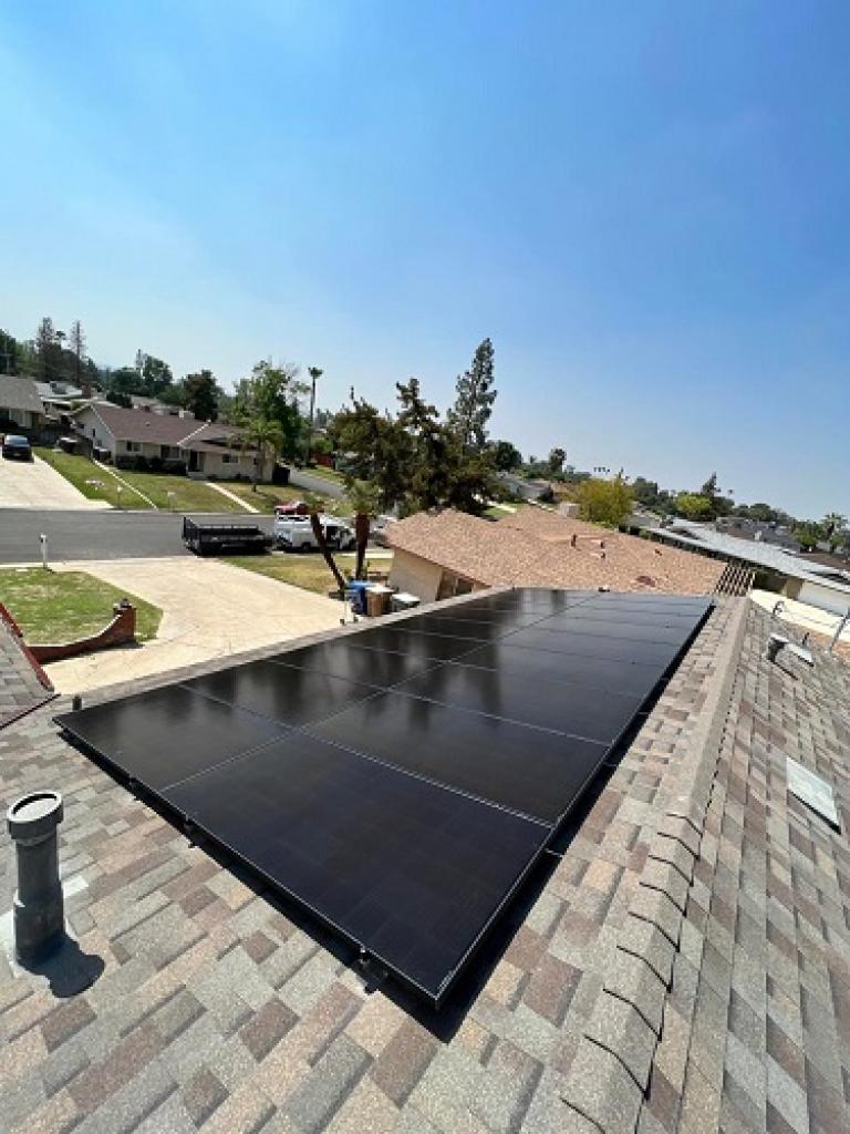black solar panels on top of house roof in Bakersfield, CA